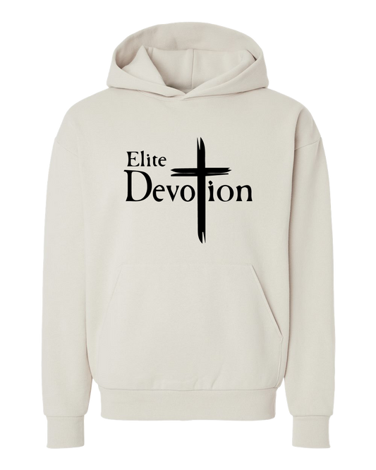 An off-white pullover hoodie with a black graphic on the chest reading 'Elite Devotion' next to a stylized cross, displayed on a solid white background.