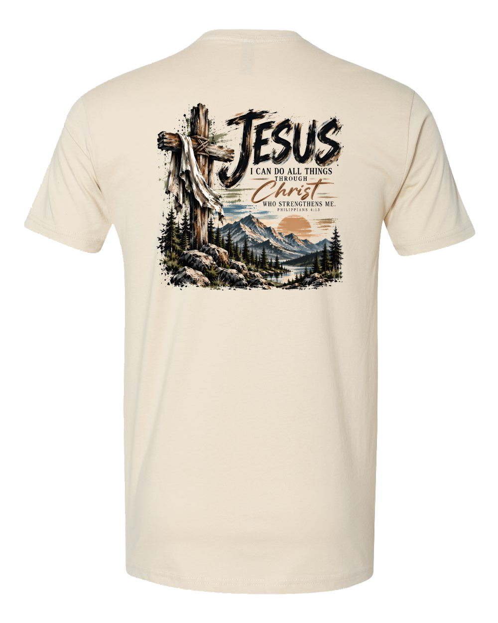 A cream-colored short-sleeve t-shirt shown from the back, featuring a large graphic print of Jesus carrying a cross with mountains, trees, and the text 'JESUS I CAN DO ALL THINGS THROUGH CHRIST WHO STRENGTHENS ME'.